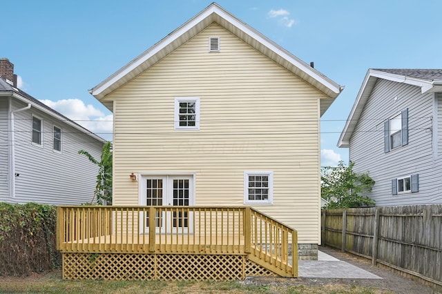 back of property with a fenced backyard and a wooden deck