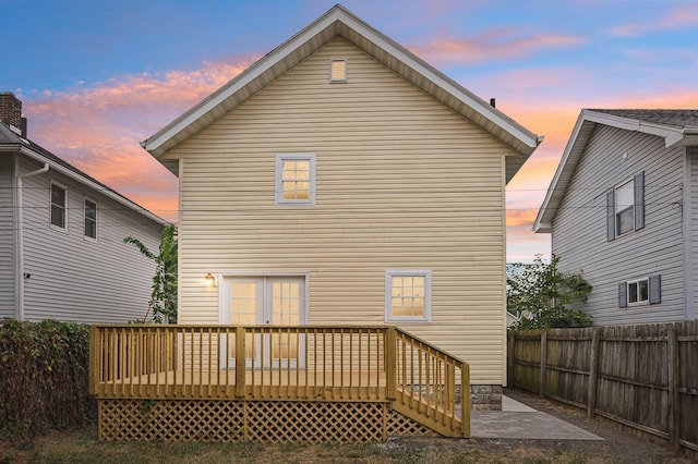 back of property featuring a patio area, a fenced backyard, and a deck