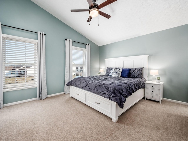 bedroom featuring baseboards, light carpet, and vaulted ceiling