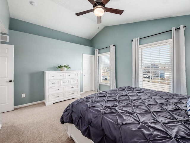 bedroom with visible vents, baseboards, light colored carpet, ceiling fan, and vaulted ceiling