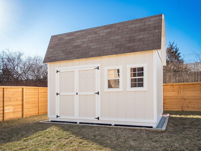 view of shed with a fenced backyard