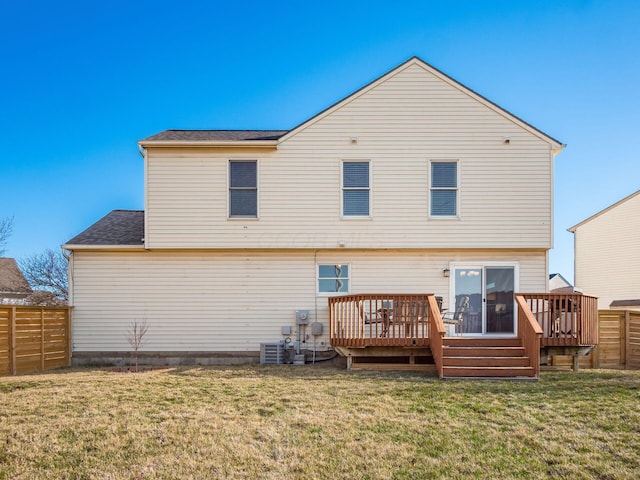 rear view of property with central AC, a lawn, a wooden deck, and a fenced backyard