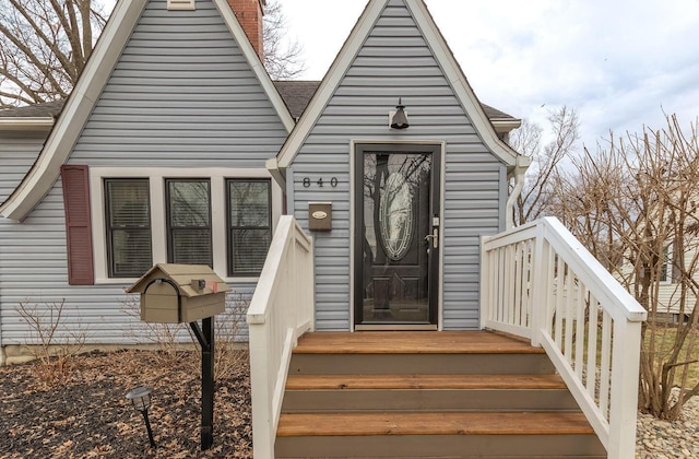 doorway to property featuring a chimney