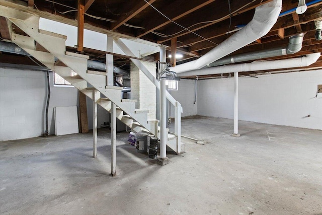 below grade area with stairs and concrete block wall