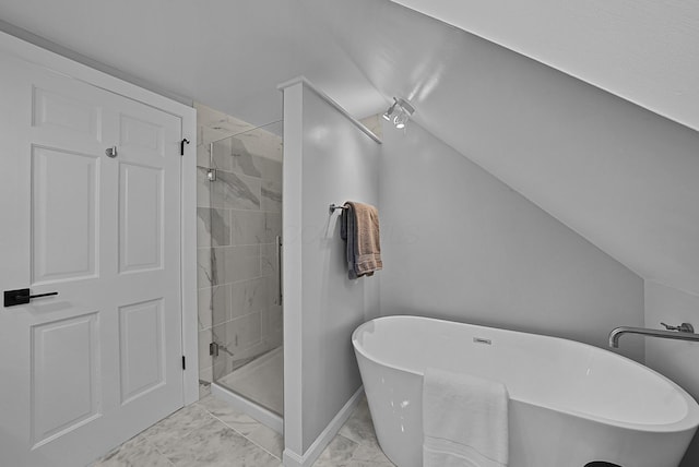 bathroom featuring baseboards, marble finish floor, vaulted ceiling, a freestanding bath, and a shower stall