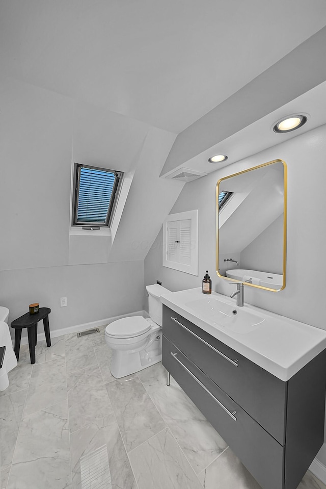 bathroom featuring visible vents, lofted ceiling, toilet, marble finish floor, and vanity