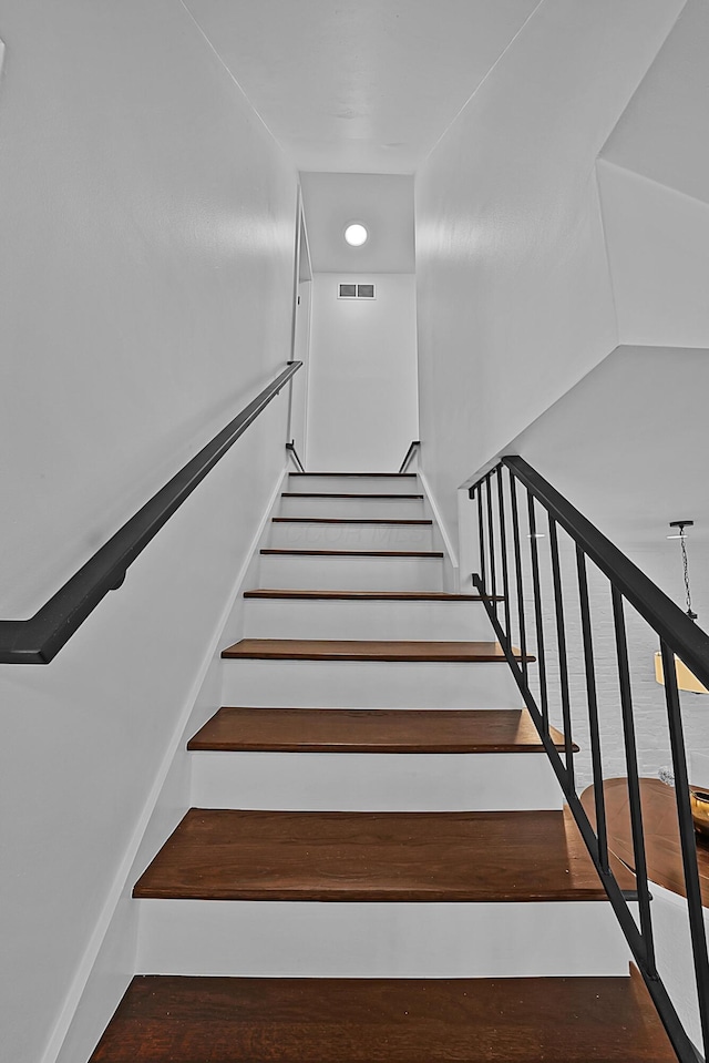 staircase featuring visible vents