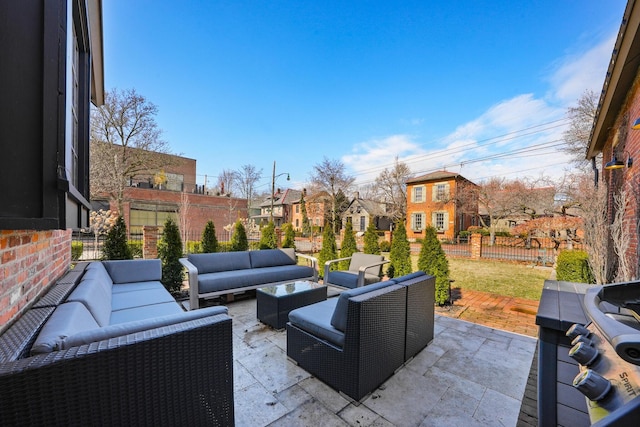 view of patio with a residential view, fence, and an outdoor living space