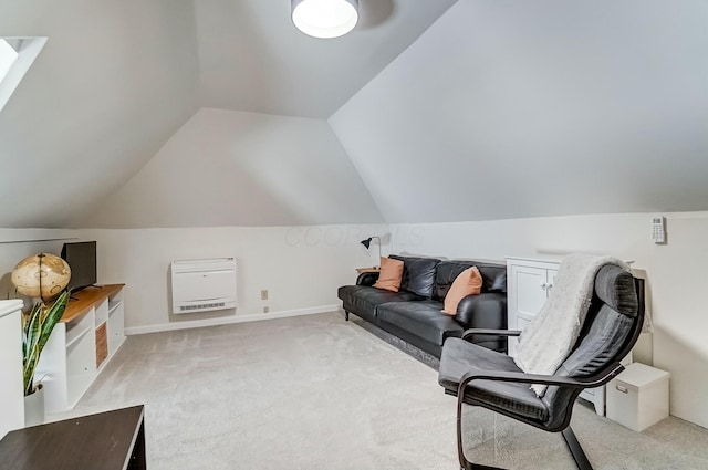 interior space with lofted ceiling, light carpet, baseboards, and heating unit