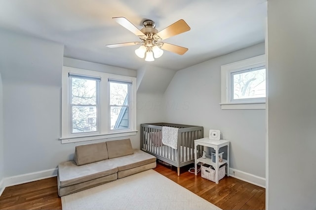 bedroom with a ceiling fan, baseboards, and wood finished floors