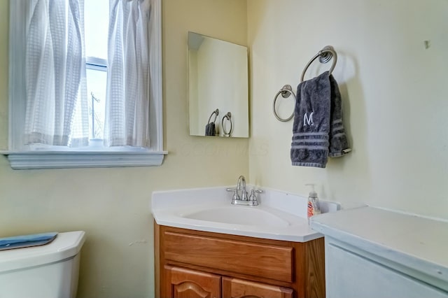 bathroom featuring vanity and toilet