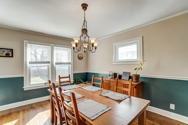 dining space with baseboards, dark wood-type flooring, and ornamental molding