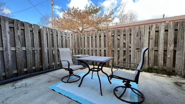 view of patio featuring fence