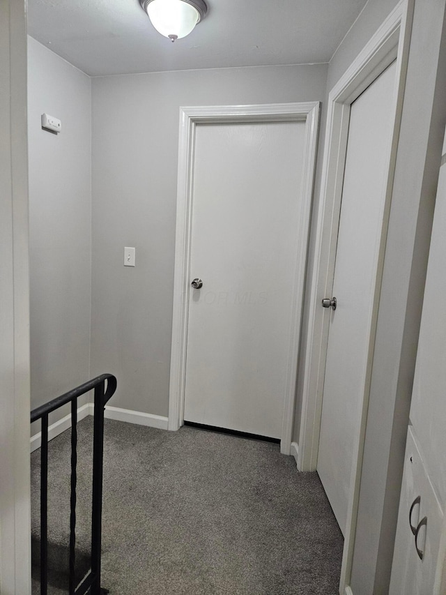 hallway with carpet and baseboards