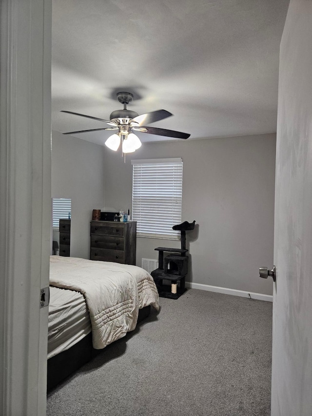 bedroom featuring a ceiling fan, baseboards, visible vents, and carpet flooring