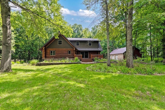 log home with a front yard, log siding, and an outdoor structure