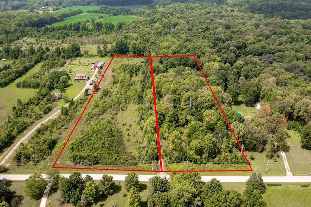 birds eye view of property with a view of trees