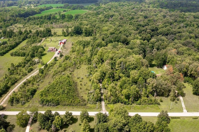 drone / aerial view with a wooded view