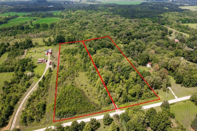 birds eye view of property with a forest view