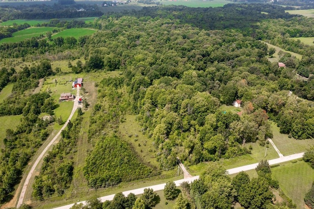 drone / aerial view featuring a forest view