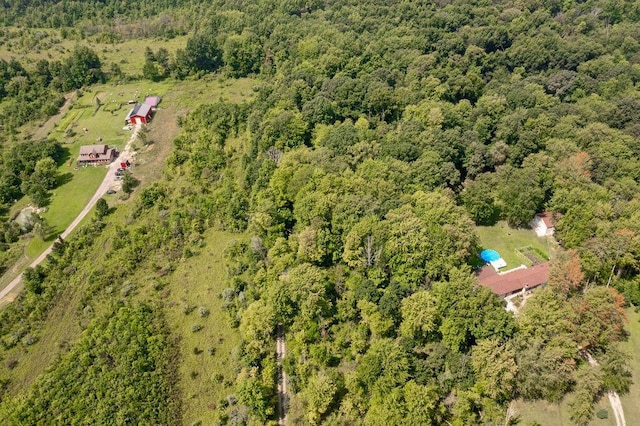 birds eye view of property featuring a view of trees