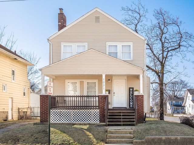 traditional style home featuring covered porch and a chimney