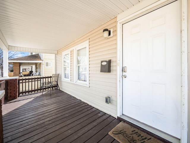 wooden terrace featuring covered porch