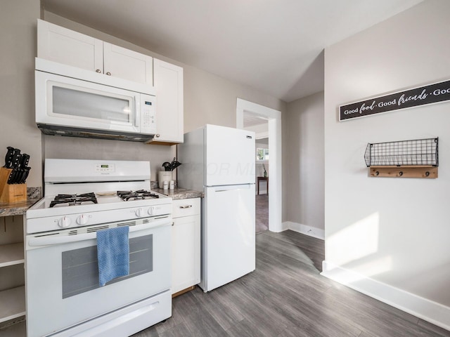 kitchen featuring dark wood finished floors, white appliances, white cabinetry, and baseboards