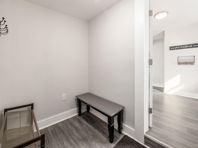 mudroom with dark wood-style floors and baseboards