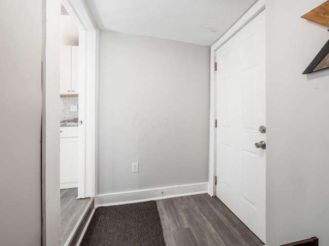 interior space with dark wood finished floors and baseboards