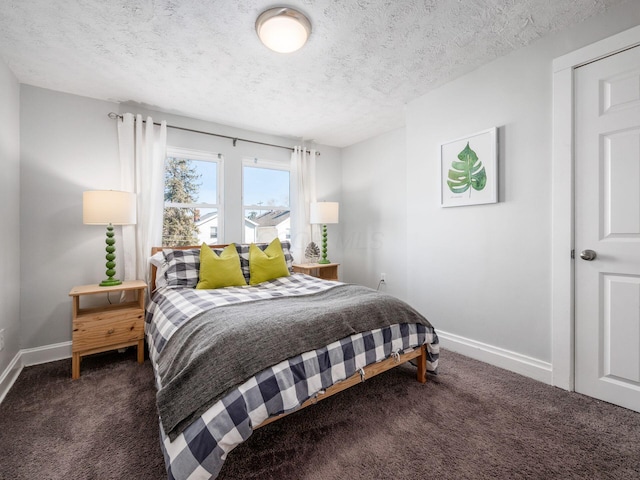 carpeted bedroom featuring baseboards and a textured ceiling