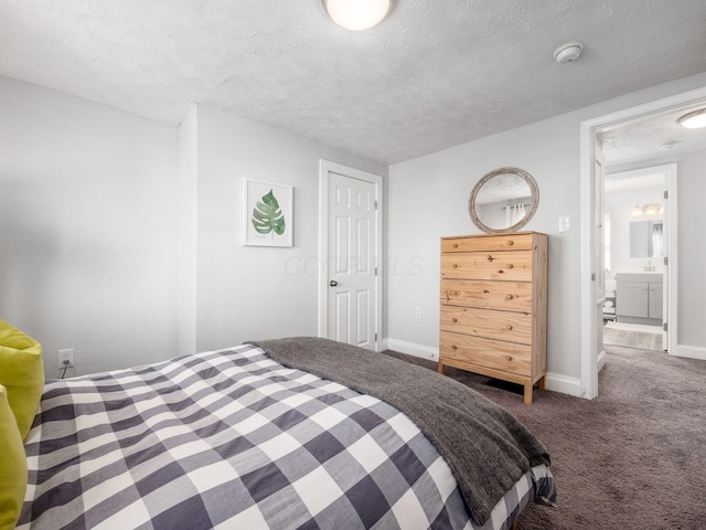 carpeted bedroom featuring a textured ceiling and baseboards