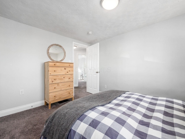 bedroom with carpet, baseboards, and a textured ceiling