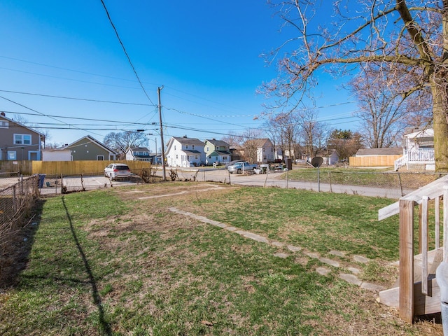 view of yard with a residential view and fence