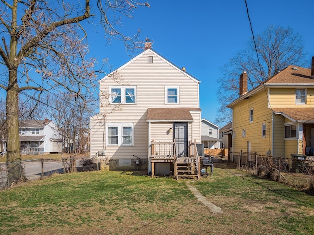 back of house featuring a yard, fence private yard, and a chimney