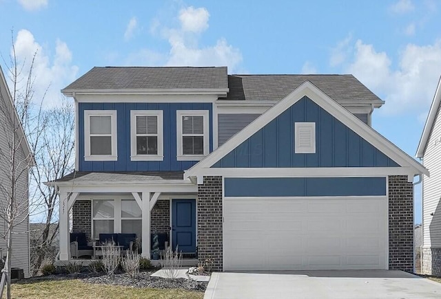 view of front of house featuring an attached garage, covered porch, brick siding, concrete driveway, and board and batten siding