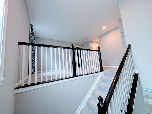 stairway featuring visible vents