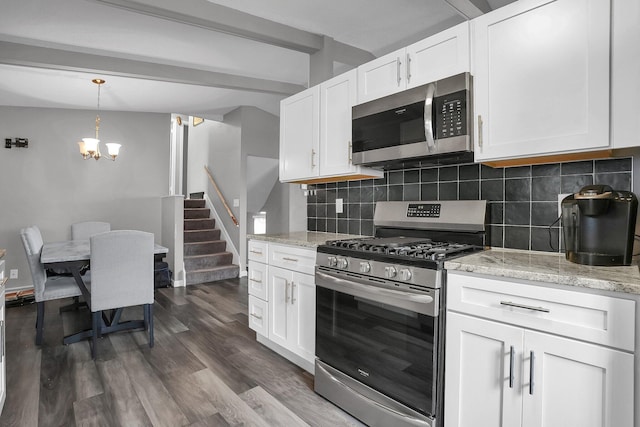 kitchen with white cabinetry, appliances with stainless steel finishes, and decorative backsplash