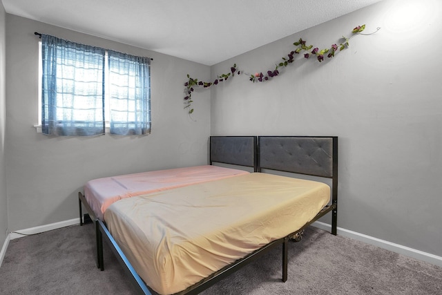 bedroom featuring carpet flooring and baseboards