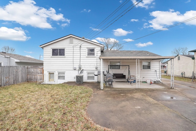 rear view of house featuring central air condition unit, a lawn, a patio, and fence