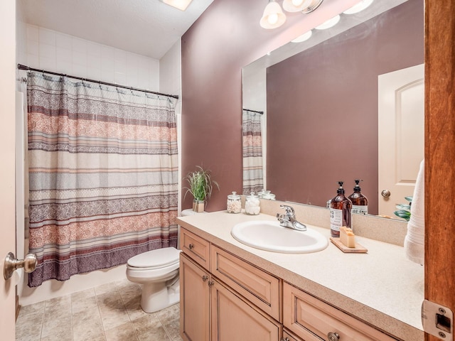 bathroom with toilet, tile patterned flooring, and vanity