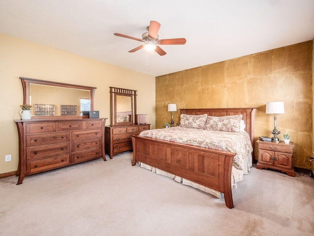 bedroom featuring a ceiling fan and light colored carpet