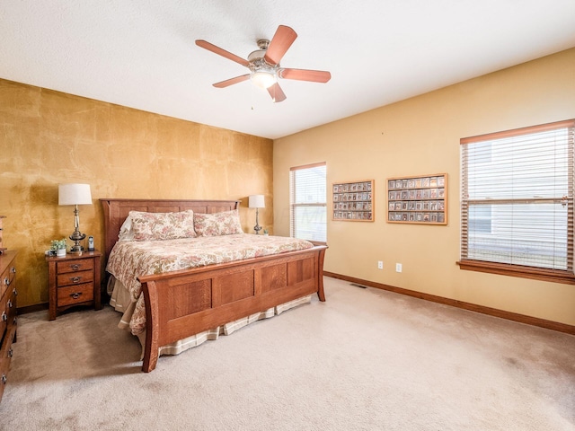 bedroom featuring a ceiling fan, carpet flooring, visible vents, and baseboards