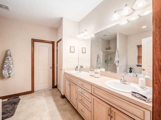 full bathroom featuring double vanity, a shower stall, visible vents, and a sink