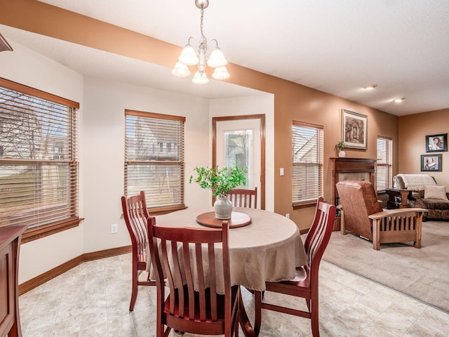 dining space featuring an inviting chandelier and baseboards