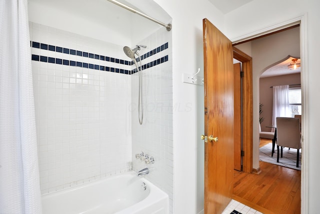 bathroom featuring shower / bathtub combination with curtain and wood finished floors