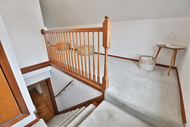 stairs featuring carpet floors and baseboards