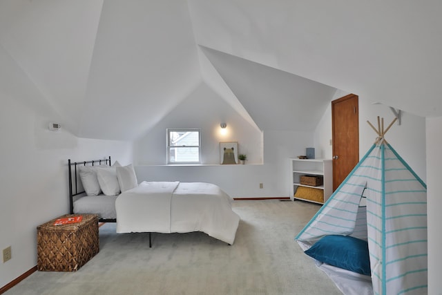 bedroom featuring lofted ceiling, carpet floors, and baseboards