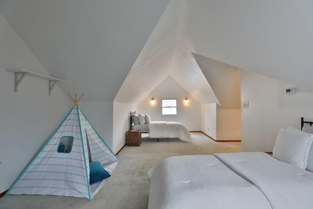 carpeted bedroom featuring baseboards and vaulted ceiling