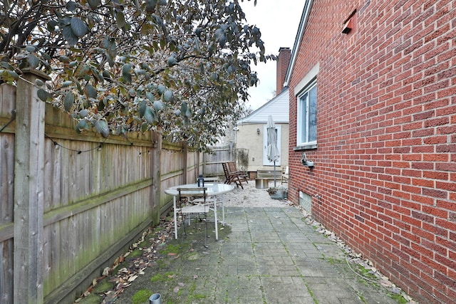 view of patio featuring entry steps and a fenced backyard